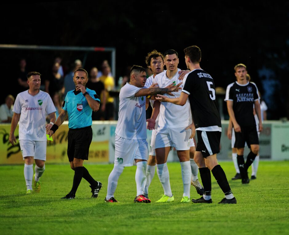 Lukas Raithofer earns a yellow card protesting Wimpassing rough play