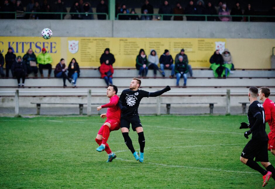 Skerlan battles Sebastian Pichler for a long forward pass