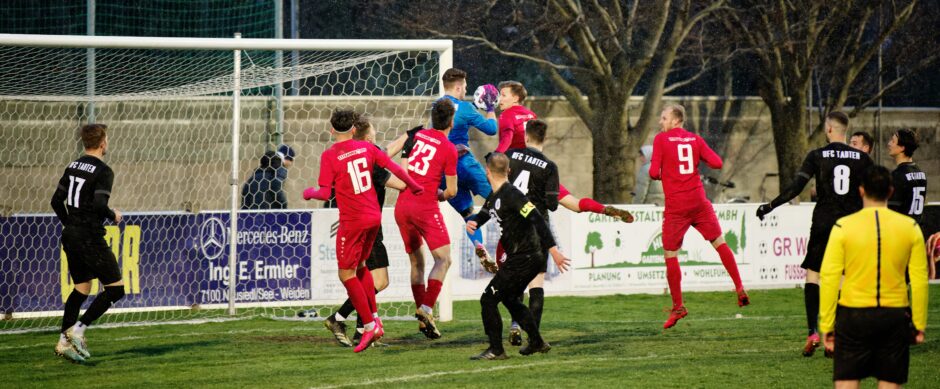 Christoph Drobela fights to head a crossing pass past Adam Klekner