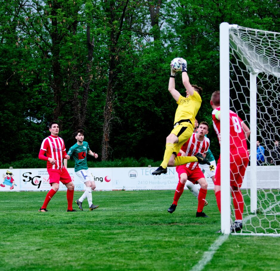 Schiszler leaping save: Keeper Manuel Schiszler leaps high in the air to catch another dangerous shot on the SC Kittsee net. In the first half, FC Monchof looked quite dominant. Schiszler's solid saves kept Kittsee in the game. Subject: Manuel Schiszler;burgenland;football;kittsee;soccer