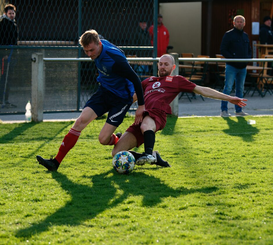 Sombat runs past Gallus 08: Gallus at least makes a pretence of going for the ball but his right leg is clearly tripping Sombat. Subject: soccer;football;burgenland;kittsee;Jozef Sombat;Peter Gallus