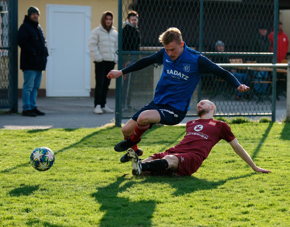 Sombat runs past Gallus 09: There's no way Sombat can avoid taking a tumble here. Subject: soccer;football;burgenland;kittsee;Jozef Sombat;Peter Gallus