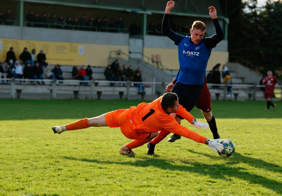 Sombat Penalty Sequence 04: Sombat starts to fall as Pentek lunges in front of him. Subject: soccer;football;burgenland;kittsee;Jozef Sombat;Julius Pentek;Andreas Roth