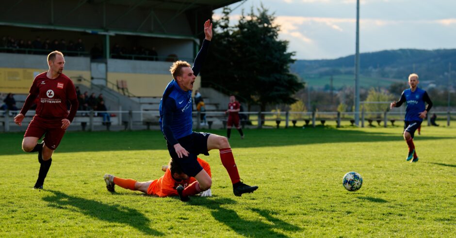 Sombat Penalty Sequence 07: Sombat falls to the ground with his arm up as the ball drifts slowly in front of the Pama net with keeper Julius Pentek on the ground. Subject: soccer;football;burgenland;kittsee;Jozef Sombat;Julius Pentek;Andreas Roth