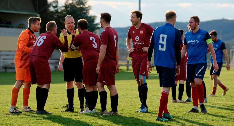 Sombat Penalty Sequence 17: Referee Markus Kouba is having none of it. He's genuinely bemused and slightly annoyed that UFC Pama won't accept his ruling. SC Kittsee captain Thomas Bastian is keeping his distance. Subject: soccer;football;burgenland;kittsee;Jozef Sombat;Julius Pentek;Andreas Roth;Markus Kouba