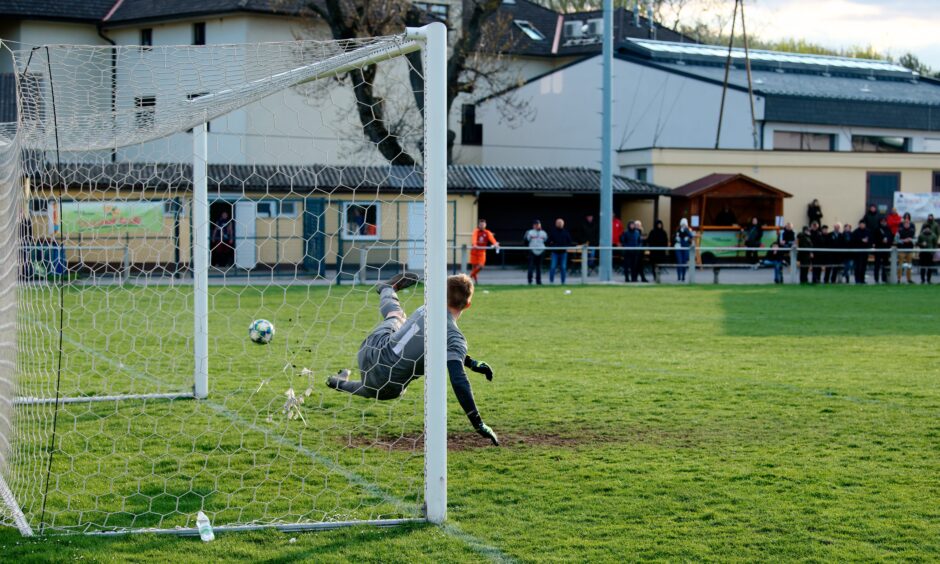 Sombat Penalty Sequence 24 Patrik Kukla guesses wrong: The penalty is taken hard by Jozef Machovec. Patrik Kukla jumps the wrong way. The ball bounces off the left post, hard. A little more touch and Machovec/SC Kittsee would have had an easy penalty goal. Subject: soccer;football;burgenland;kittsee;Patrik Kukla