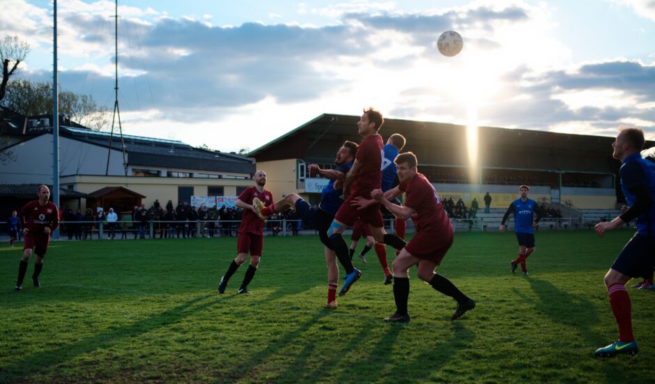 Ball floats away: As the sun sets, SC Kittsee's chances are slowly floating away with this deflected header. Subject: soccer;football;burgenland;kittsee;Christoph Werdenich;Christoph Drobola;Josef Machovec