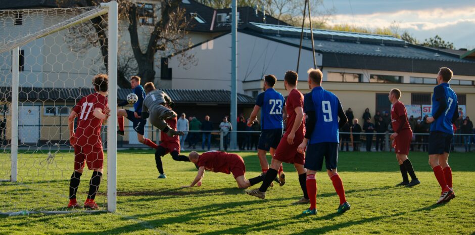 Jozef Sombat sends Patrik Kukla flying: Coming down fast on the right wing, Jozef Sombat lures Patrik Kukla well out of net but is unable to put the ball in the open UFC Pama net. Subject: soccer;football;burgenland;kittsee;Jozef Sombat;Patrik Kukla