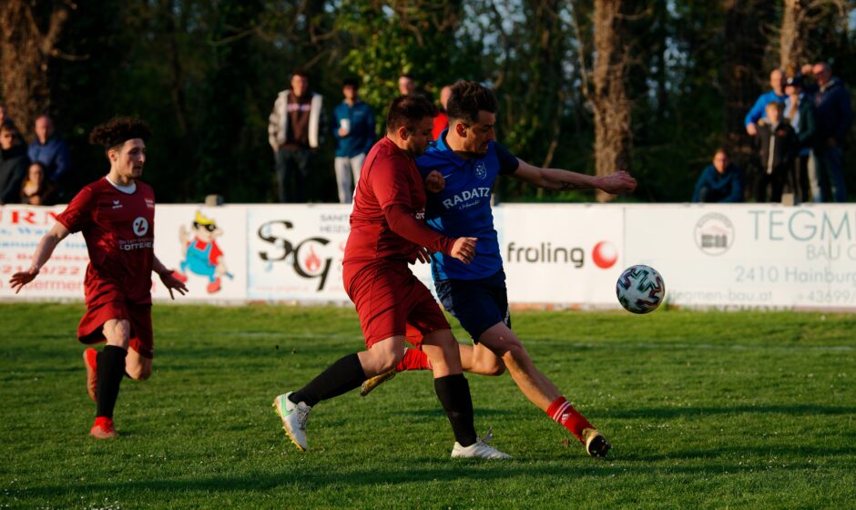 Machovec and Lackner fight for the ball: Markus Lackner bumps Josef Machovec hard on the left wing as Machovec attempts to send in a crosser. Subject: soccer;football;burgenland;kittsee;Josef Machovec;Markus Lackner