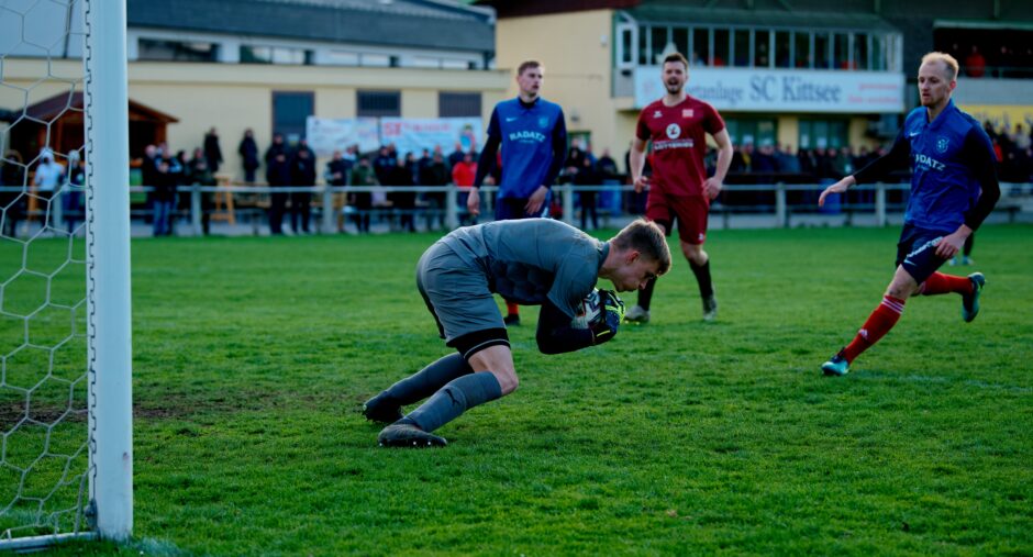 Patrik Kukla makes the save: Patrik Kukla covers up the ball from Josef Machovec's close header. Kukla didn't have to do much with all the SC Kittsee shots going off goalposts but this was an important save. Nothing left for a scavenging Michal Andrasik. Subject: soccer;football;burgenland;kittsee;Josef Machovec;Patrik Kukla;Michal Andrasik