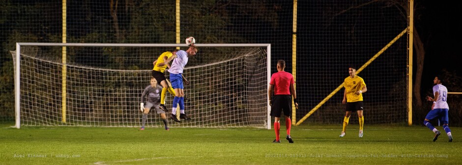 Jozef Sombat competes for header with Carsten Lang: Even our good chances were mostly mediocre like this one where Szombat heads the ball but keeper Michael Unger is at the ready with eyes on the ball and few Kittsee attackers nearby. Carsten Lang continues to mark Szombat closely. Subject: SC Kittsee;ASV Deutsch Jahrndorf;II Liga Nord;Burgenland;soccer;football;Michael Unger;Jozef Szombat;Carsten Lang