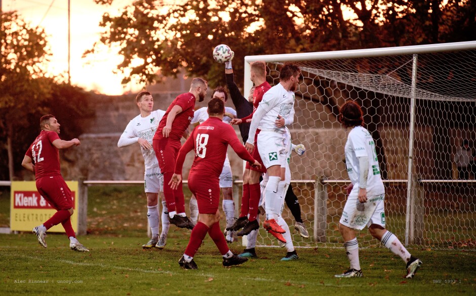 Scrum in front of the FC Illmitz net: FC Illmitz keeper Patrick Kamper gets a hand on this one, under siege from both Michael Wernecker and Jozef Szombat Subject: soccer;football;burgenland;kittsee;SC Kittsee;FC Illmitz;Patrick Kamper;Michael Wernecker;Jozef Szombat