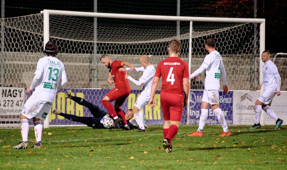 Michael Wernecker attempts to push a loose ball into the net: Michael Wernecker attempts to push a loose ball into the net. Thomas Sazl holds Wernecker while keeper Kemper tries to block the ball. The second half of the game turned into a bit of a nightmare for Kemper with SC Kittsee forwards in front of him in one on one or two on one situations again and again. Subject: soccer;football;burgenland;kittsee;SC Kittsee;FC Illmitz;Michael Wernecker;Thomas Sazl;Patrick Kemper