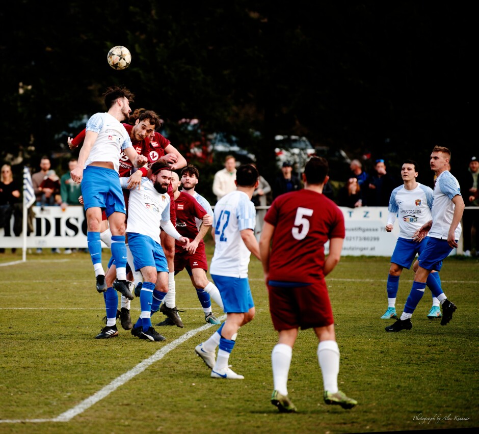 Jaroslav Machovec wins header in front of Kittsee net: Jaroslav Machovec was a beast on this day, leaping and smashing headers in front of the both the Kittsee and Pama nets. Sadly his timing with Jozef Sombat was badly off so all of the hard work came to naught.

This picture is in colour for reference: colour of uniforms, grass, light. Subject: Christoph Drobola;Christoph Werdenich;Jaroslav Machovec;Juraj Fuska;burgenland;football;kittsee;soccer