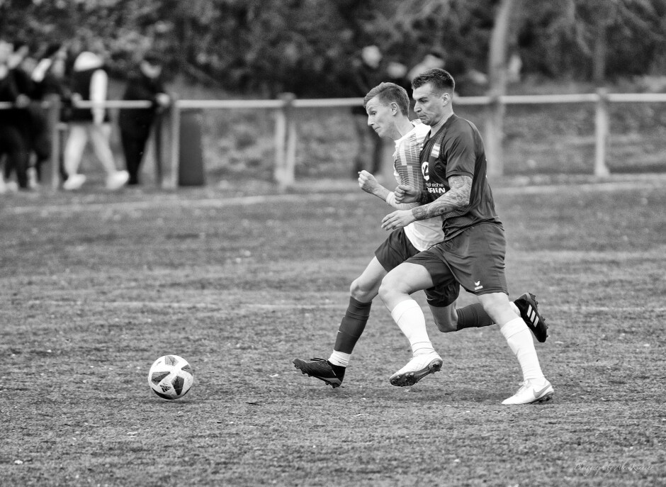 Erik Micovcak muscles Christoph Drobola off the ball: Christoph Drobola struggles to maintain his line on the ball against the very experienced and stronger Erik Micovcak Subject: soccer;football;burgenland;kittsee;Erik Micovcak;Christoph Drobola