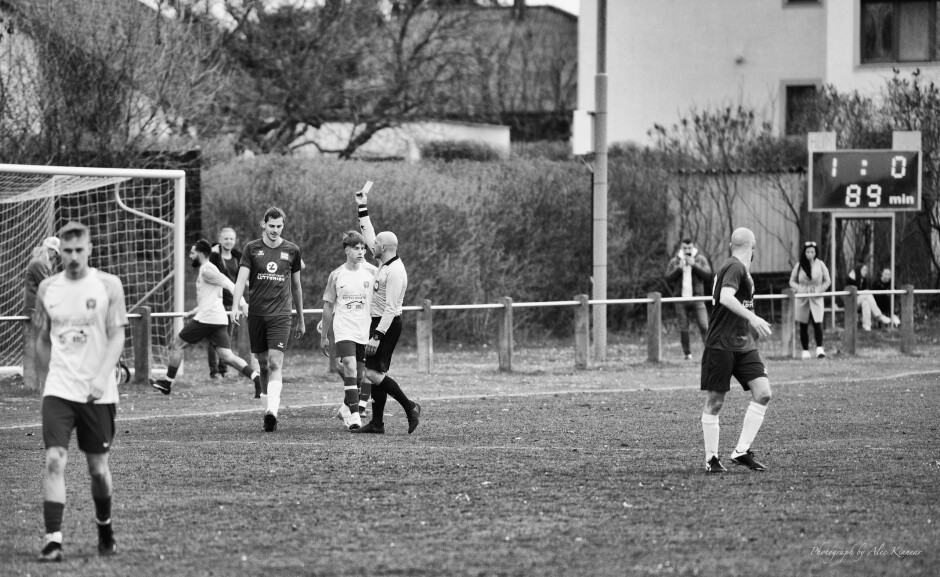 Andreas Fabsich kicks the ball into the bushes: At 89 minutes Andreas Fabsich kicks the ball into the bushes which Michal Belko was trying to retrieve for a header. Bearded Juraj Fuska is running after the ball in the bushes in the background.

Fabsich earns a well-deserved yellow card from referee  Arif Erdem for unsportsmanlike conduct. Surely Erdem just added thirty seconds to penalty time. What's the point of this kind of dirty play? Subject: soccer;football;burgenland;kittsee;Andreas Fabsich;Michal Belko;Arif Erdem;Juraj Fuska