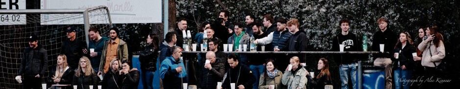 Kittsee party bench: White cups everywhere as the young Kittsee home bench crowd cheer on their team and laugh and joke. Subject: soccer;football;burgenland;kittsee;SC Kittsee;FC Winden;Kittsee fans