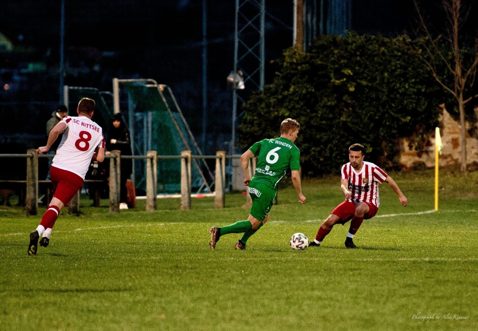 Patrick Dietmann defends Marek Luscik: Though down 1:0 for much of the match, FC Winden pressed hard on the all second half. Subject: soccer;football;burgenland;kittsee;SC Kittsee;FC Winden;Patrick Dietmann;Marek Luscik;Tomas Bastian