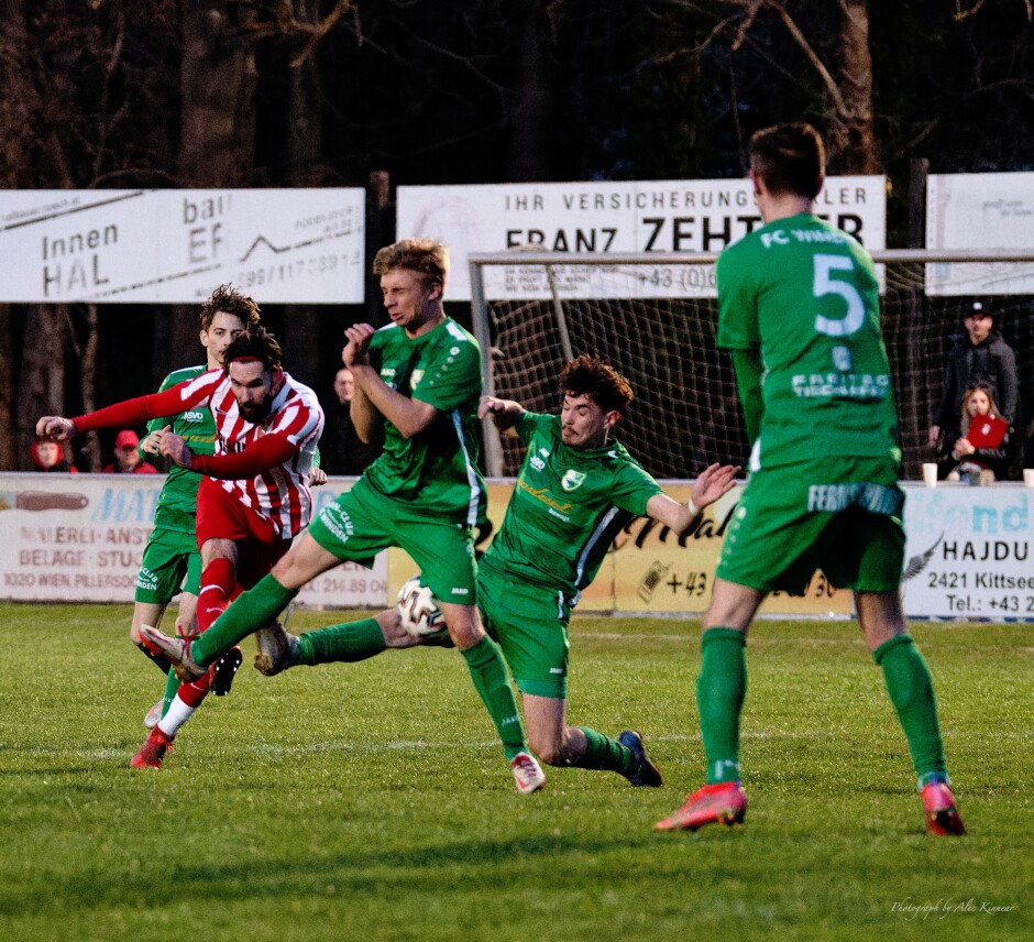 Juraj Fuska hammers a hard shot: Fuska's hard shot goes into a bevy of Winden players including Sascha Savoric and Maximilian Kroyer Subject: soccer;football;burgenland;kittsee;SC Kittsee;FC Winden;Juraj Fuska;Sascha Savoric;Maximilian Kroyer