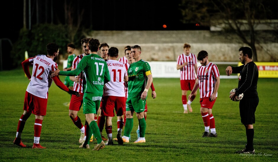 Post-game handshake as referee Durdu Ceri checks time: Apart from some pushing and shoving between Wernecker and Balazi, the game tonight was both very competitive and very clean. SC Kittsee deserved to win, FC Winden deserved no worse than a tie for their performance. This is what football is all about. From left to right: Juraj Fuska, Filip Balazi, Mustafa Atik, Patrick Pail, Michael Speckl, Tomas Banovic, Manuel Oswald, referee Durdu Ceri. Subject: soccer;football;burgenland;kittsee;SC Kittsee;FC Winden;Juraj Fuska;Filip Balazi;Mustafa Atik;Patrick Pail;Michael Speckl;Tomas Banovic;Manuel Oswald;Durdu Ceri.