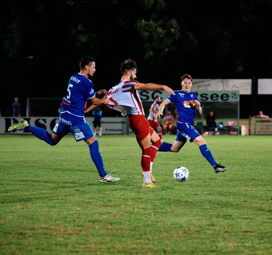 Shirt tackle: Image 1/3: Patrik Petrak is worried enough about Frantisek Nagy to just grab his shirt and throw him to the ground even with Alexander Wendelin running to intercept him. Subject: SC Kittsee;SV Gols;burgenland;football;kittsee;soccer