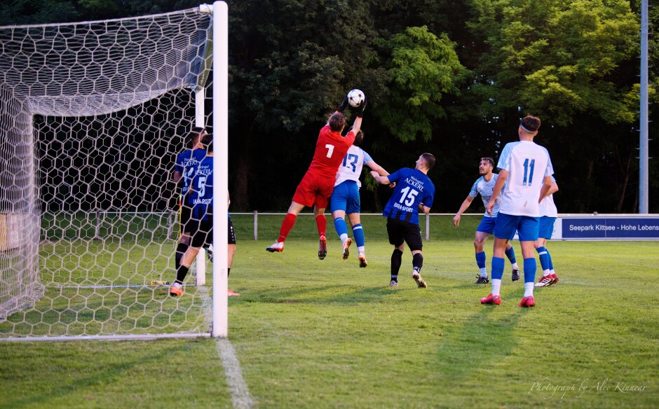 Lukas Mock catches another header: Manuel Oswald can't get enough air to knock the ball past Mock. Yet another busy set of action in front of the Steinbrunn net which came to naught. Subject: SC Kittsee;UFC Tadten;burgenland;football;kittsee;soccer