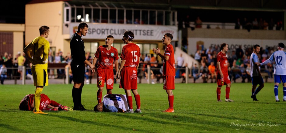 Martin Hudak, Aleksandar Stanojcic lie prone: How Breitenbrunn hoped to have their foul overturned by referee Nikica Veselcic with both players injured was a mystery to me. One can see how short the Breitebrunn team is collectively. Short but very lively. Subject: soccer;football;burgenland;kittsee;SC Kittsee;SC Breitenbrunn;Martin Hudak;Aleksandar Stanojcic;Nikica Veselcic;Peter Barinec