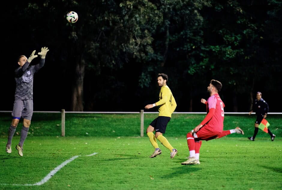 Michael Unger saves a long ball from Michal Belko: Kittsee continues to press with Ibrahim Kamasik and Jozef Sombat in close on net hoping for a drop from keeper Michael Unger. Defender Ömer Faruk Akbiyik ignores the two attackers, watches his keeper and hopes for the best. Subject: soccer;football;burgenland;kittsee;SC Kittsee;ASV Deutsch Jahrndorf