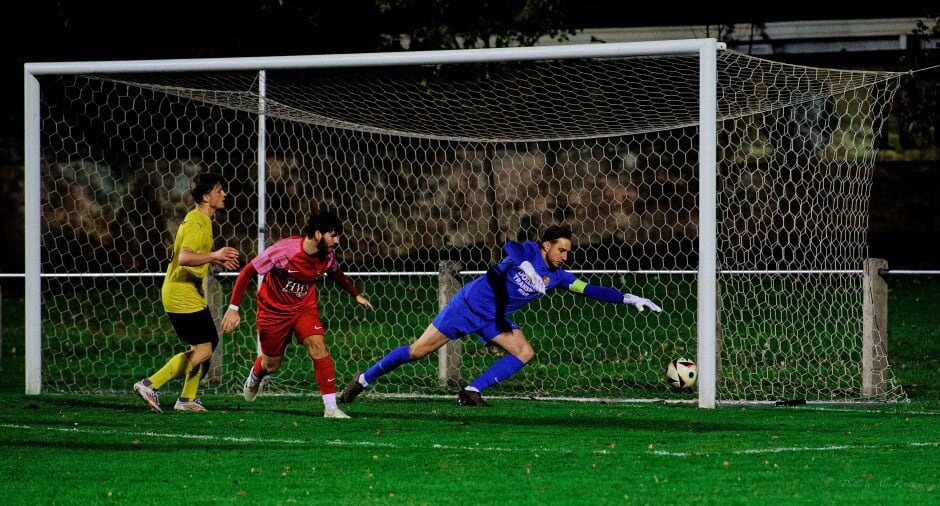 Just wide: Manuel Schiszler keeps a good angle to force Borys Brydniak's shot wide. Manuel Oswald watches the dangerous ball roll. Subject: soccer;football;burgenland;kittsee;SC Kittsee;ASV Deutsch Jahrndorf